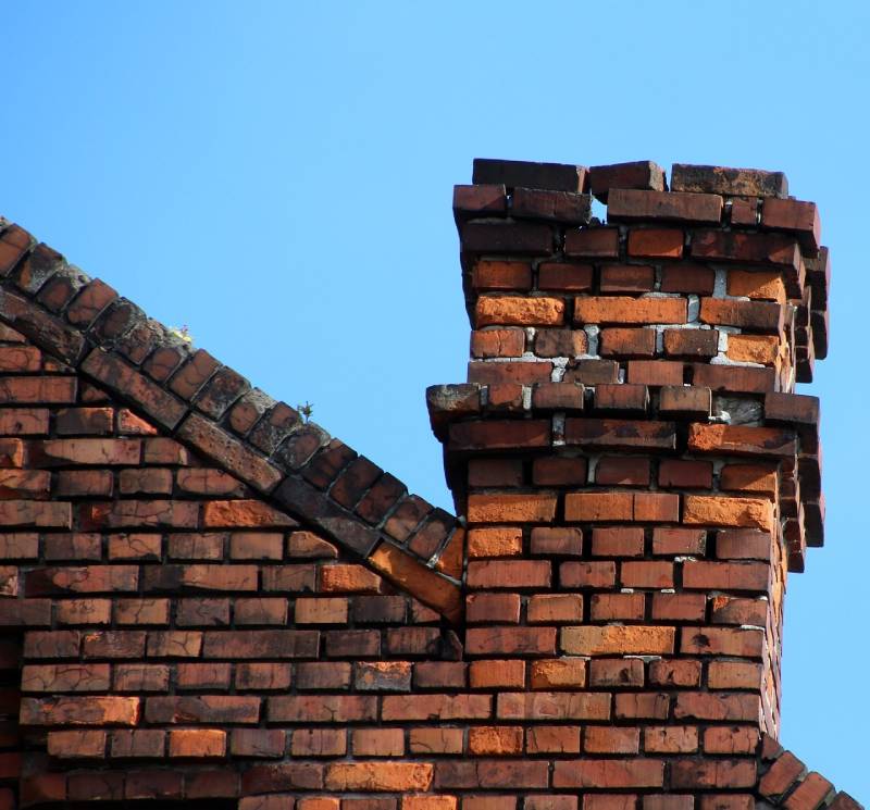 Signs Your Orland Park Home Needs a Chimney Inspection Damaged chimney on an Orland Park home showing cracks and missing mortar